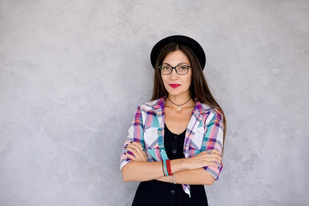 Attractive hipster girl in glasses and hat