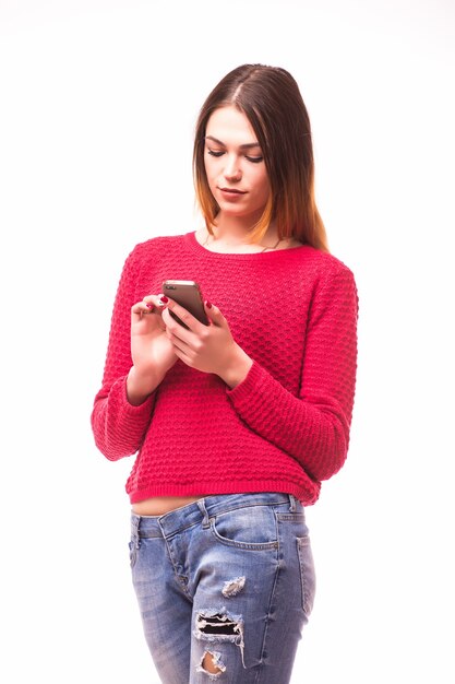 Attractive hipster girl wearing glasses and using her smartphone for texting