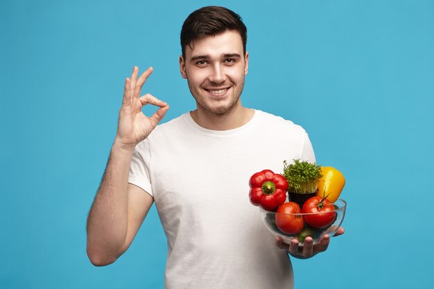 Attractive joyful young customer or chef with happy smile posing in studio