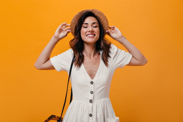 Attractive lady in stylish hat sincerely smiling on isolated background