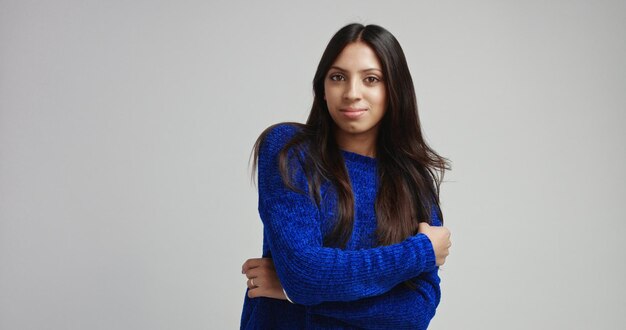 Attractive Latino female model in warm bright blue sweater