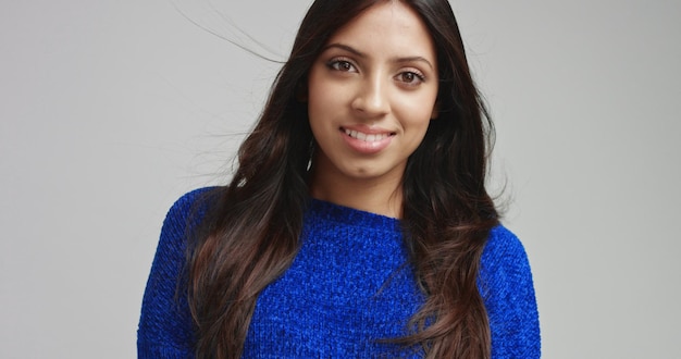 Attractive Latino female model in warm bright blue sweater