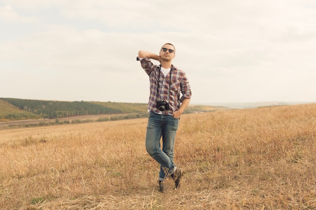 Attractive male photographer outdoors at sunset