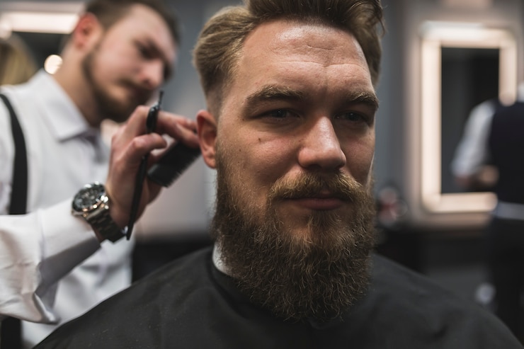 Free Photo attractive man having hair cut