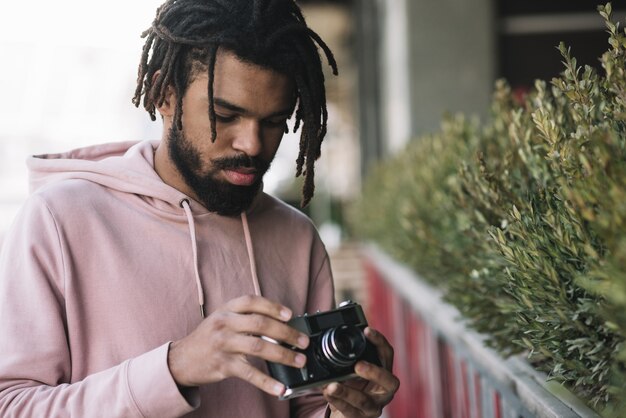 Attractive man holding camera