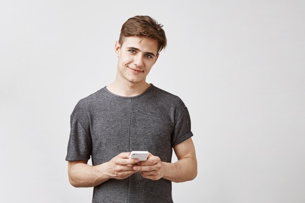 Attractive man posing with smartphone