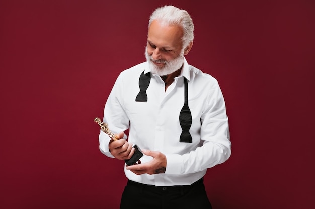 Attractive man in suit holds Oscar statuette