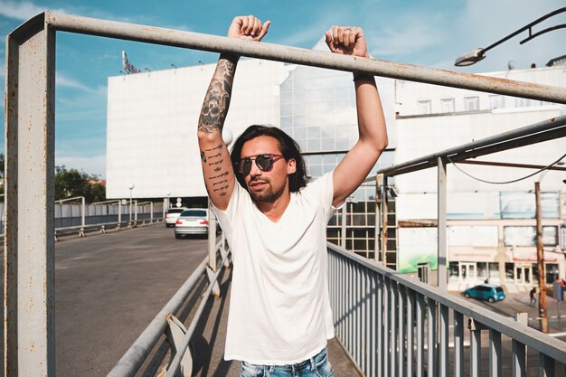 Attractive man with sunglasses hanging out in the city