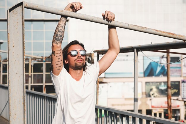 Attractive man with sunglasses hanging out in the city