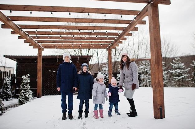 Free photo attractive mother with her four kids in winter day