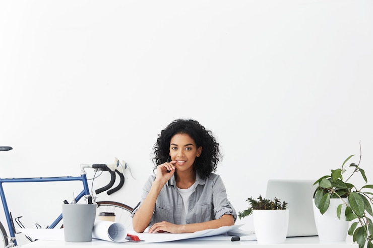 Free Photo attractive positive young mixed race female architect working from home