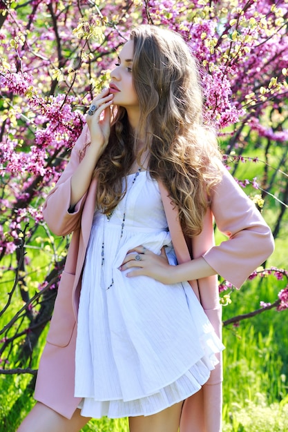 Attractive pretty young woman in light white dress