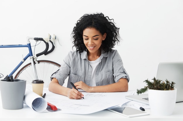 Attractive self-employed dark-skinned designer enjoying new interesting engineering project