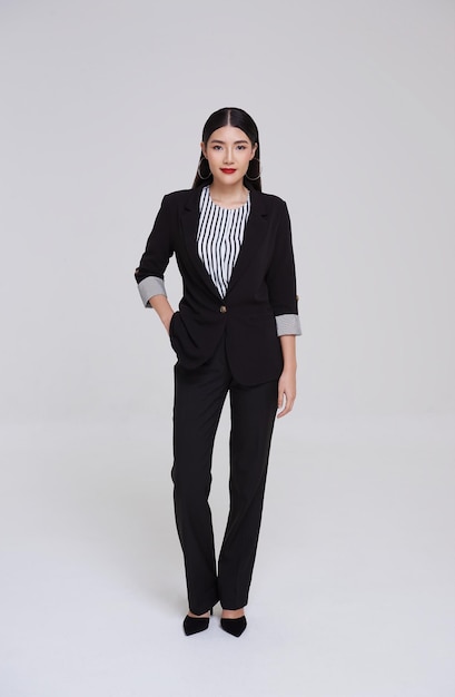 Free photo attractive smart asian businesswoman in suit standing with looking at camera