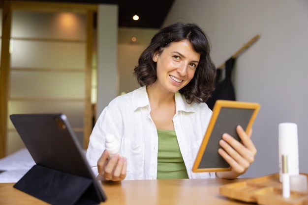 Attractive smiling woman looking at camera at home