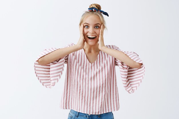 Attractive stylish girl posing against the white wall