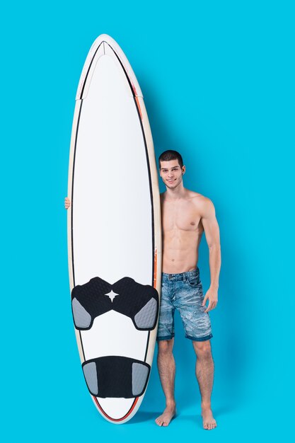 Attractive surfer holding a surfboard