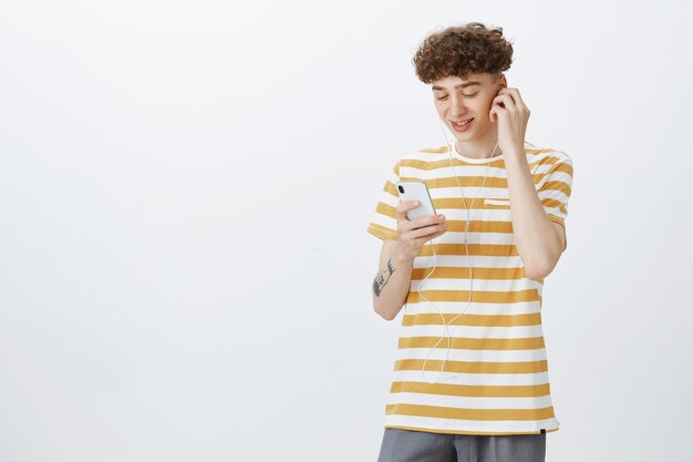 Attractive teenage guy posing against the white wall