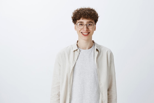 Attractive teenage guy posing against the white wall