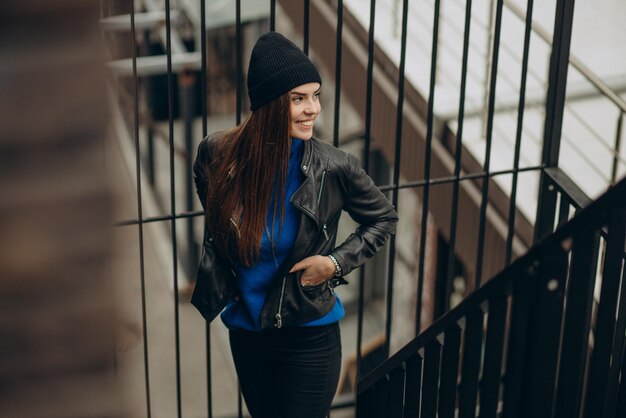 Attractive wom an standing in the street wearing black jacket