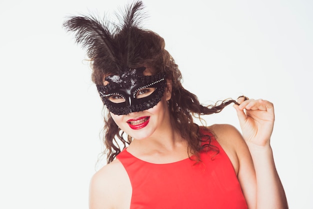 Attractive woman in black mask with feathers