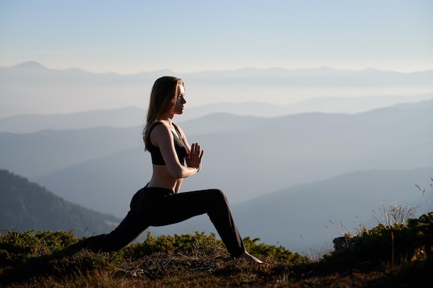 Attractive woman doing exercises on nature