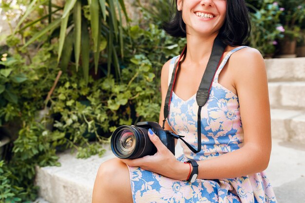 Привлекательная женщина в платье, путешествуя в отпуске в Европе у моря в круизе, фотографируя на камеру