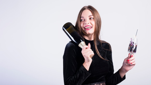 Attractive woman holding bottle of champagne