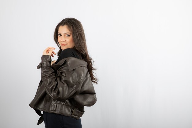  attractive woman in jacket standing and posing . 