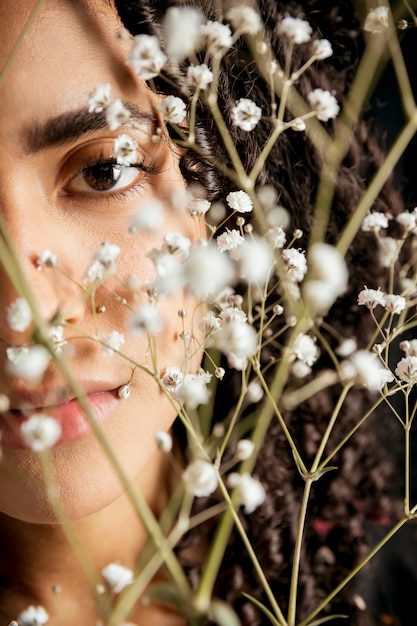 Attractive woman looking through twigs