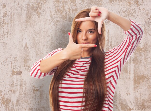 Attractive woman making photo gesture 