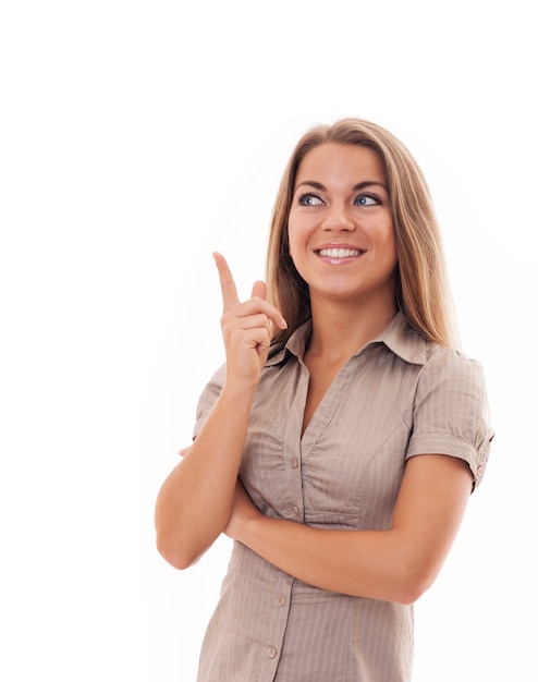 Attractive woman pointing at copyspace