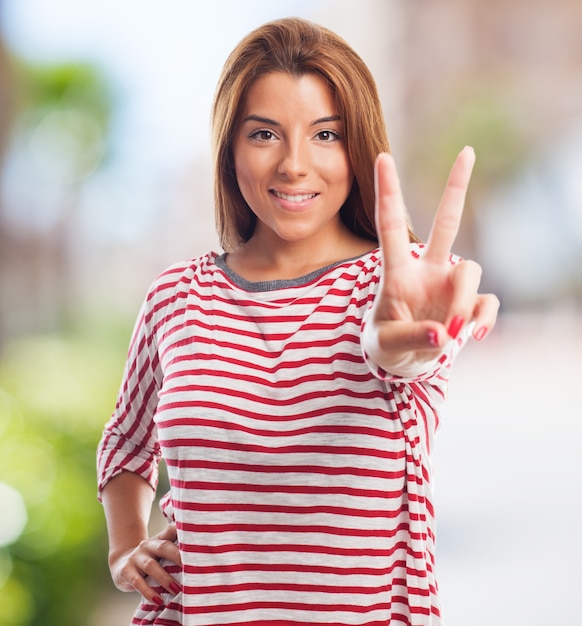 Free photo attractive woman showing peace sign