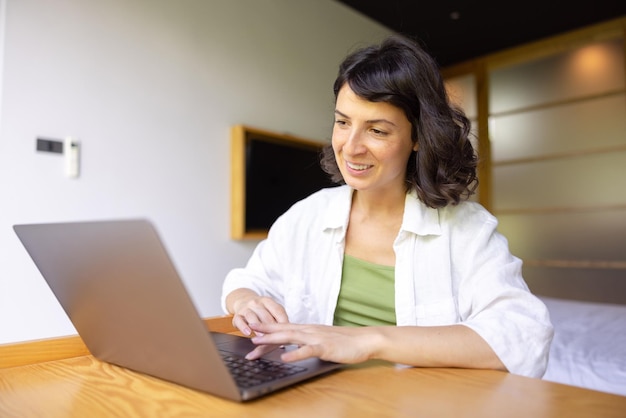 Attractive woman sitting at home and working