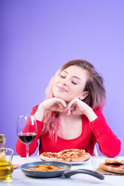 Attractive woman sitting at the table with eyes closed