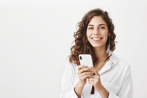 Attractive woman using mobile phone, download application