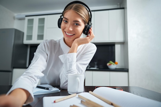 Free photo attractive woman wearing headphones during video call