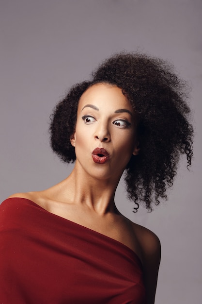 Attractive woman with afro hairstyle surprised