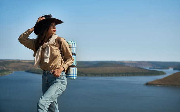 Attractive woman with backpack hiking alone at bakota area