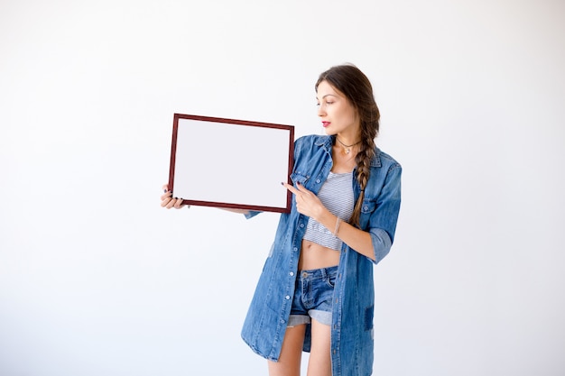 Attractive woman with empty blank white placard or poster