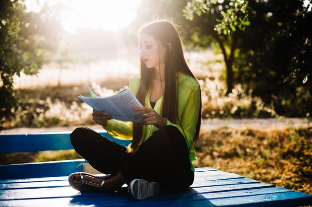 Attractive woman with papers in park