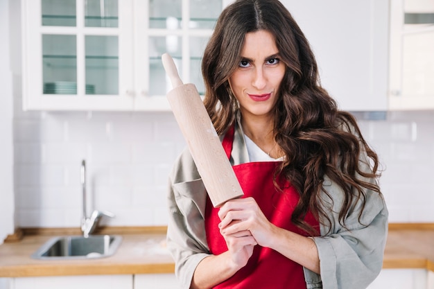 Attractive woman with rolling pin