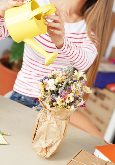 Attractive woman with watering can