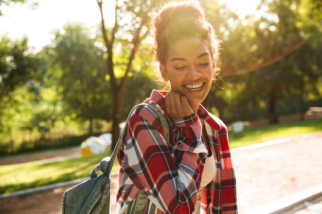 Attractive young african woman walking outdoors