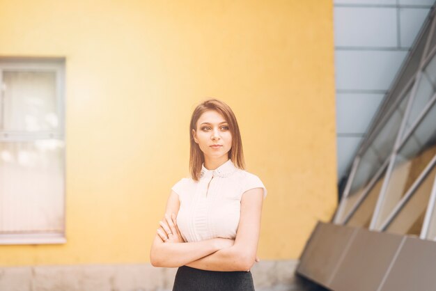 An attractive young businesswoman with her arms crossed