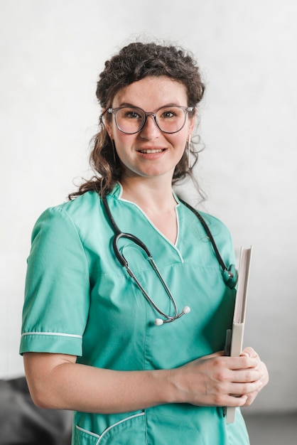 Attractive young female nurse with stethoscope around her neck