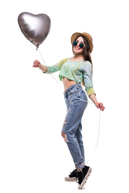 Attractive young girl holding Valentine's Day helium balloon isolated on white