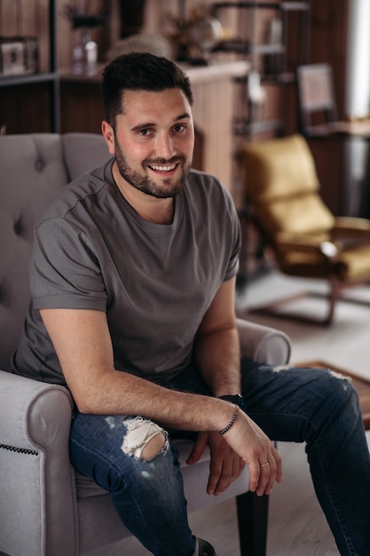 Free photo attractive young man is relaxing at home