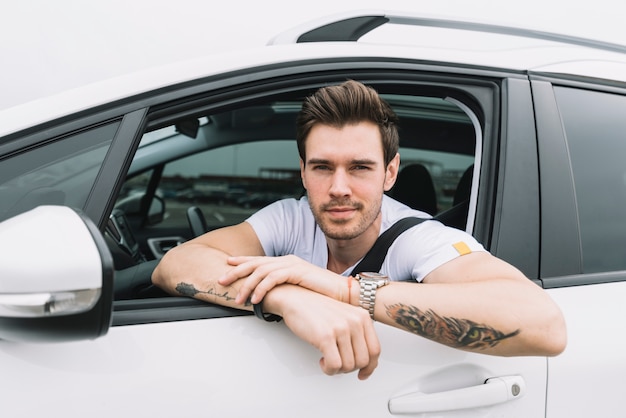 An attractive young man looking out of car window