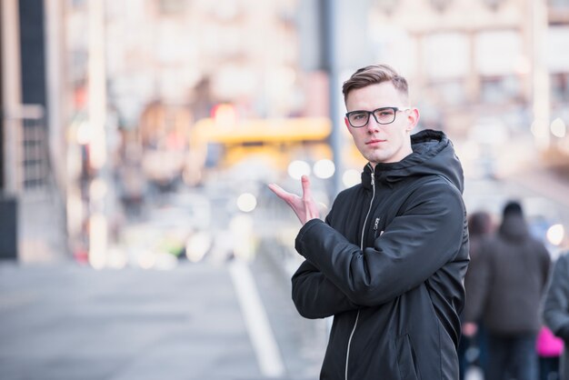 An attractive young man standing on road gesturing